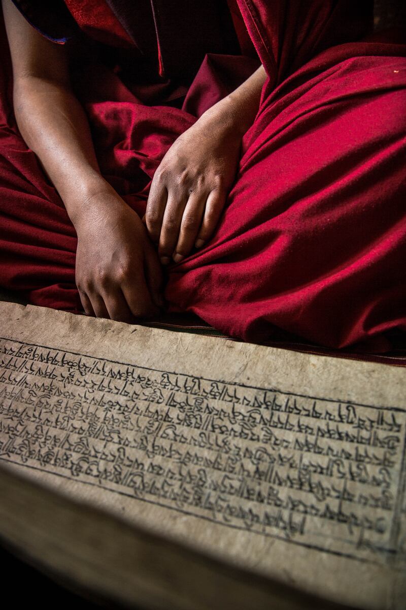 A Buddhist monk reads scriptures in eastern Bhutan. So strong is the belief in yetis here that the government of Bhutan has created a national park dedicated to protecting the yetis said to live in the area 