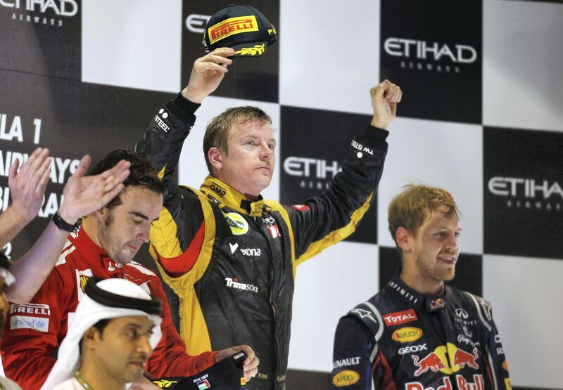 ABU DHABI, UNITED ARAB EMIRATES - NOVEMBER 04:  Kimi Raikkonen of Finland and Lotus celebrates on the podium after winning the Abu Dhabi Formula One Grand Prix at the Yas Marina Circuit on November 4, 2012 in Abu Dhabi, United Arab Emirates.  (Photo by Paul Gilham/Getty Images)