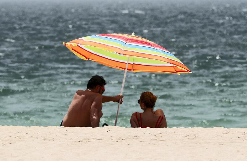 DUBAI, UNITED ARAB EMIRATES , June 27 – 2020 :- Visitors during the hot and humid weather at the Kite beach in Dubai. (Pawan Singh / The National) For Standalone