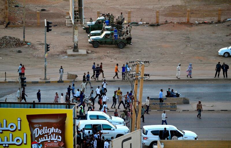 Members of Sudan's intelligence services shoot bullets in the air at the headquarters of the Directorate of General Intelligence Service. AFP