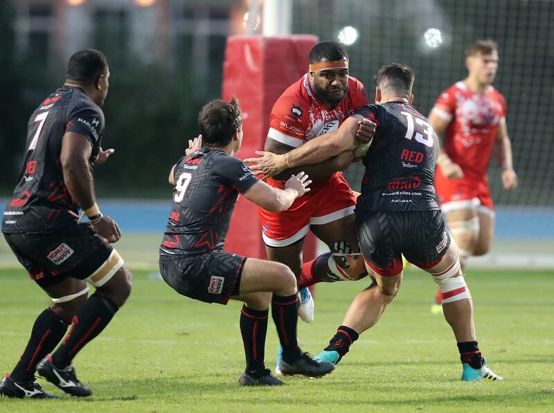 Tigers' Emosi tries to break through the Exiles defence.