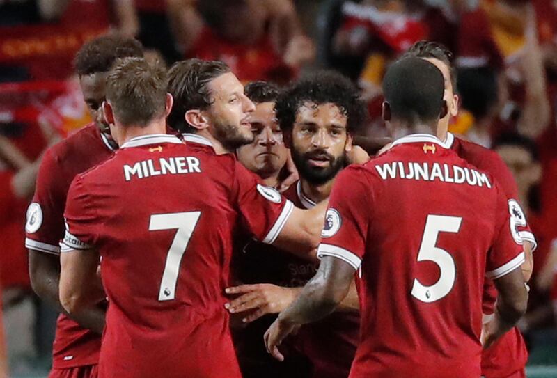 Liverpool's Mohamed Salah, center celebrates after scoring a goal during the final match against Leicester City FC at the Premier League Asia Trophy soccer tournament in Hong Kong, Saturday, July 22, 2017. (AP Photo/Kin Cheung)