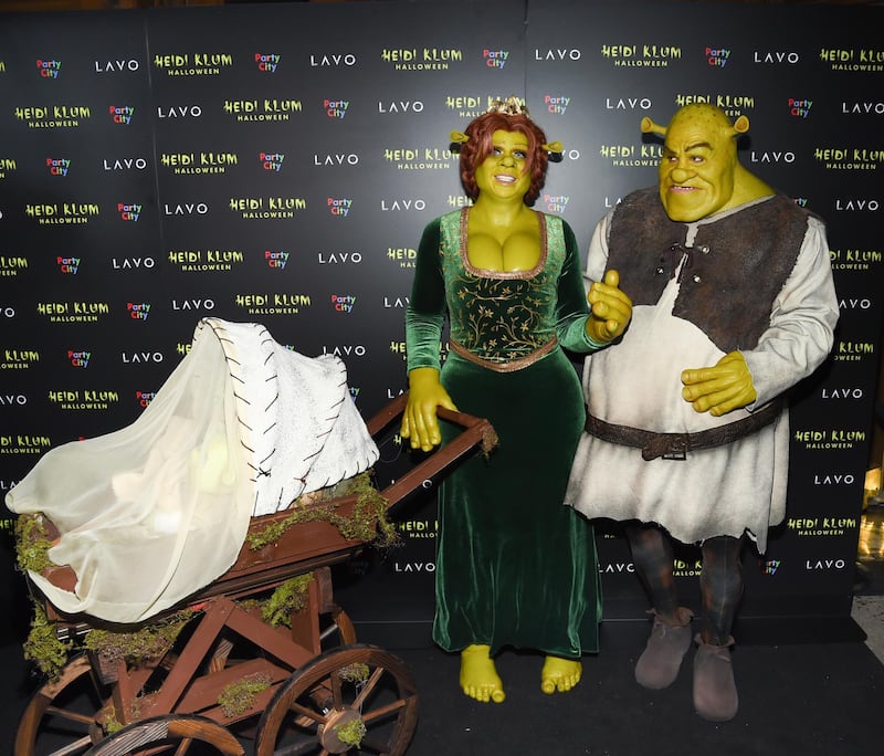 Heidi Klum and boyfriend Tom Kaulitz are dressed as Shrek and Princess Fiona arrive at her 19th annual Halloween party at Lavo New York. All photos by AP