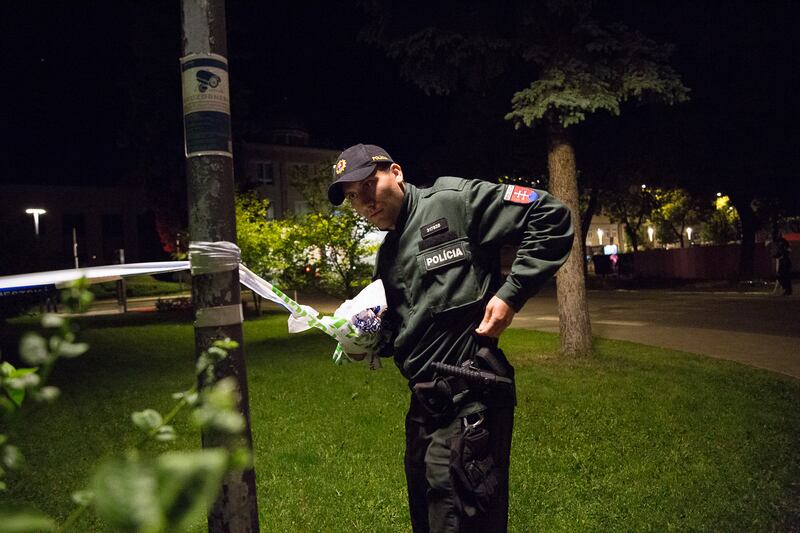 Police remove tape at the scene of the shooting in Handlova. Getty Images