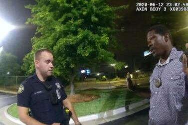 FILE- In this June 12, 2020 file photo from a screen grab taken from body camera video provided by the Atlanta Police Department Rayshard Brooks speaks with Officer Garrett Rolfe in the parking lot of a Wendy's restaurant, in Atlanta. Rolfe has been fired following the fatal shooting of Brooks and a second officer has been placed on administrative duty. The Fulton County District Attorney will announce charging decisions in the fatal shooting of Brooks during a news conference, Wednesday, June 17, 2020 in Atlanta. (Atlanta Police Department via AP, File)