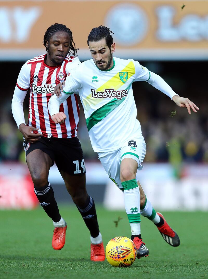 BRENTFORD, ENGLAND - JANUARY 01:  Romaine Sawyers of Brentford tackles Mario Vrancic of Norwich City during the Sky Bet Championship match between Brentford and Norwich City at Griffin Park on January 01, 2019 in Brentford, England. (Photo by Bryn Lennon/Getty Images)