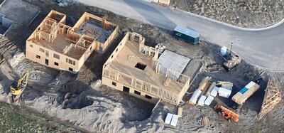 ADVANCE FOR RELEASE SATURDAY MAY 25, 2019, AND THEREAFTER - This April 13, 2019, photo, shows homes being built in suburban Salt Lake City. For millennials looking to buy their first home, the hunt has felt like an anxious race against the clock. (AP Photo/Rick Bowmer)