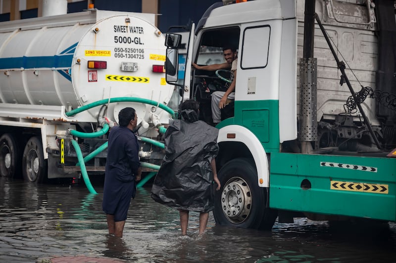 Workers clear standing water in Dubai. Antonie Robertson/The National