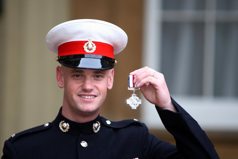 Royal Marine Cpl John Thompson after receiving the Conspicuous Gallantry Cross from Queen Elizabeth II at Buckingham Palace in November 2007. PA