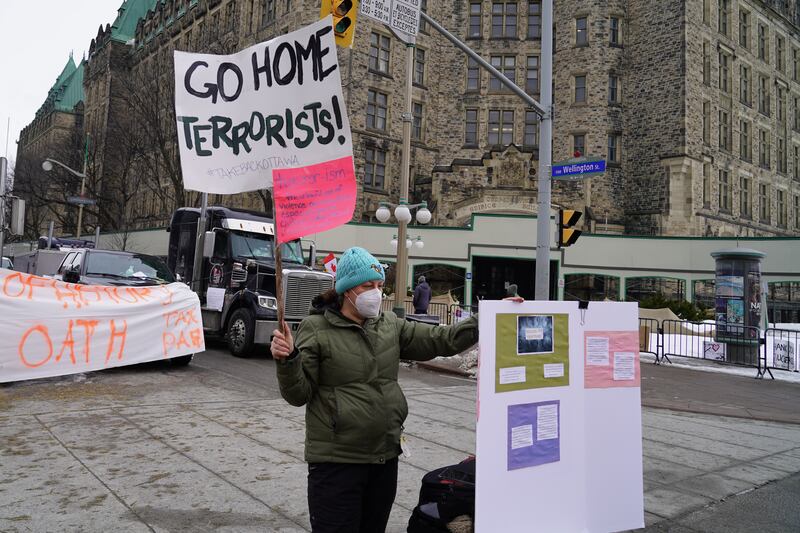 A counter-protester stands near the anti-vaccine protesters in central Ottawa. Willy Lowry / The National