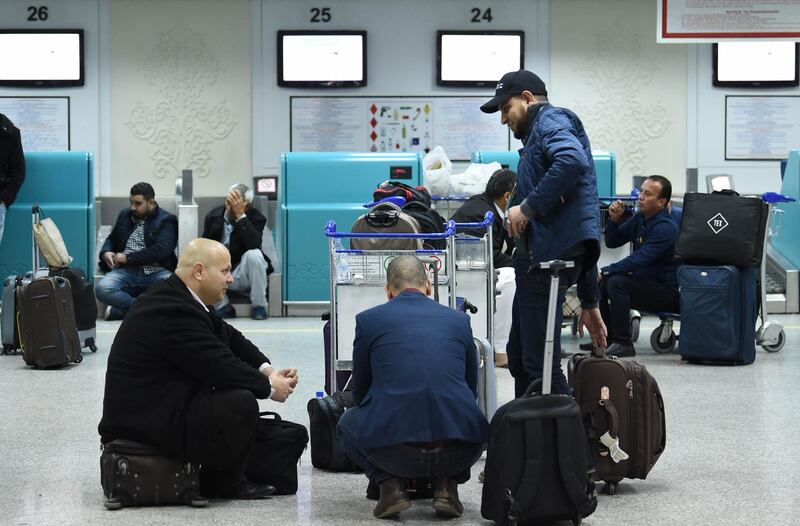 Tourists wait at Tunis-Carthage airport after the announcement of the cancellation of all flights. AFP