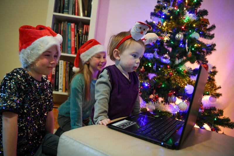 Children Zoe, Gwen, and Rory Godfrey talk to Santa on Zoom in Crantock, England. Getty Images