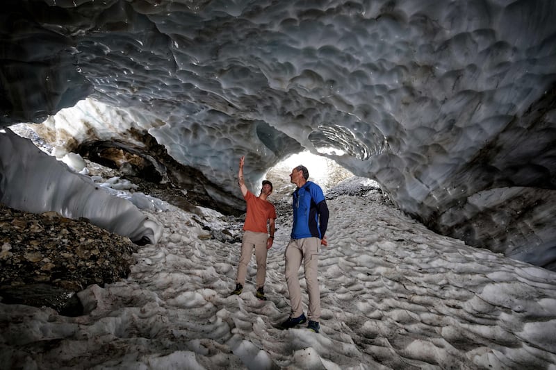 French glaciologist Pierre Rene, right, and French snowboarder Mathieu Crepel in the Oulettes de Gaube glacier, in the Pyrenees National Park, near Cauterets, Hautes-Pyrénées, France.  AFP