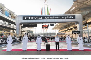 Sheikh Saif bin Zayed, Deputy Prime Minister and Minister of Interior (3rd L) stands for the national anthem prior to the f2020 Formula 1 Etihad Airways Abu Dhabi Grand Prix, at Yas Marina Circuit. Seen with Mohamed bin Sulayem, FIA Vice President and President of the Automobile and Touring Club for the UAE (L) Khaldoon Al Mubarak, CEO and Managing Director Mubadala, Chairman of the Abu Dhabi Executive Affairs Authority and Abu Dhabi Executive Council Member (2nd L) and Chase Carey, Formula 1 Chairman and CEO during the Al Fursan flyover. Ministry of Presidential Affairs 