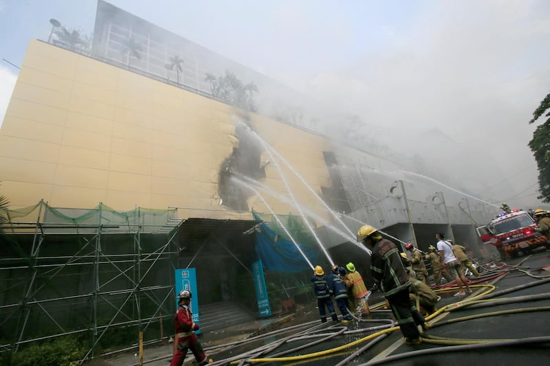 Firefighters douse water after a fire engulfed the Manila Pavilion hotel in Metro Manila, Philippines on March 18, 2018. Romeo Ranoco / Reuters