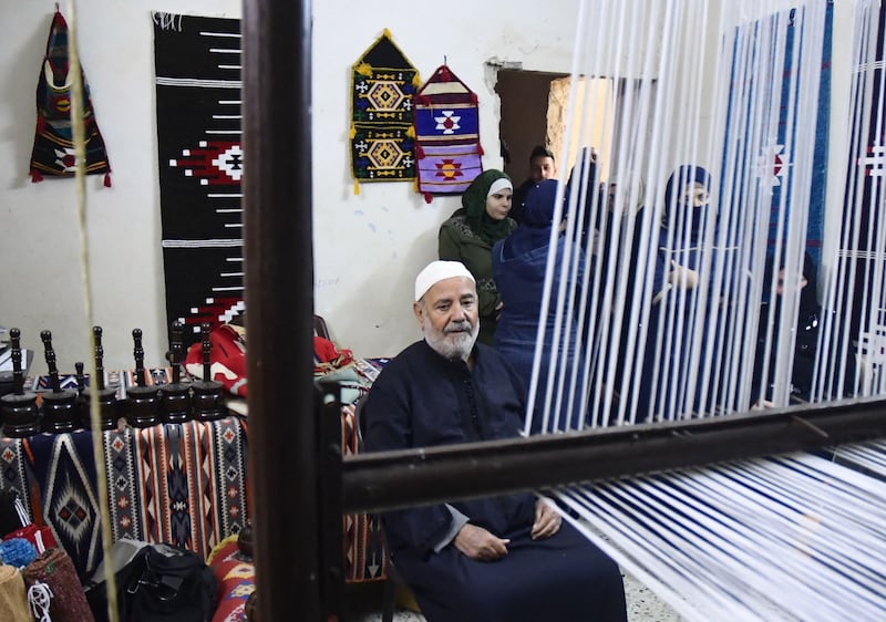 Abdel Kader Khosayyem, 70, a traditional kilim weaver, is pictured at his workshop in the northern Syrian city of Aleppo. All photos: AFP