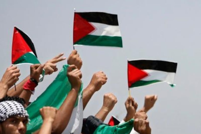epa02767312 Palestinian protesters hold Palestine National Flags during a protest near the Erez border crossing between the northern Gaza Strip and Israel on 05 June 2011  as Israeli security forces go on high alert while Palestinian activists in Jerusalem, the West Bank, Gaza and Arab states bordering Israel plan demonstrations on the 44th anniversary of the 1967 Six Day War  EPA/ALI ALI *** Local Caption ***  02767312.jpg