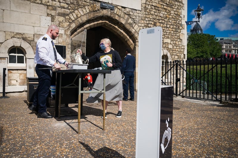 A tourist has her bag searched following a ceremonial event to mark the reopening to the public of the Tower of London. Getty Images