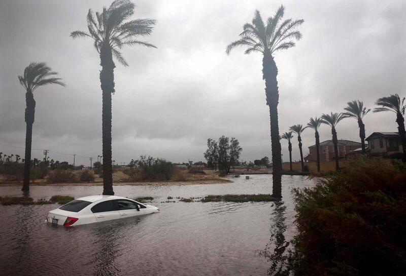 CATHEDRAL CITY, CALIFORNIA - AUGUST 20: A car is partially submerged in floodwaters as Tropical Storm Hilary moves through the area on August 20, 2023 in Cathedral City, California.  Southern California is under a first-ever tropical storm warning as Hilary impacts parts of California, Arizona and Nevada.  All California state beaches have been closed in San Diego and Orange counties in preparation for the impacts from the storm which was downgraded from hurricane status.    Mario Tama / Getty Images / AFP (Photo by MARIO TAMA  /  GETTY IMAGES NORTH AMERICA  /  Getty Images via AFP)