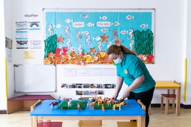 A staff member arranges sanitised toys at British Orchard Nursery. Reem Mohammed / The National