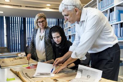 Abu Dhabi, United Arab Emirates, November 16, 2017:    Dr. Eng. Athol Yates of Khalifa University, right, leads volunteers, Tiffany Malnor, centre, and Angelika Hamilton while researching past UAE disasters in archived newspapers at the National Archives near the Zayed Sports City area of Abu Dhabi on November 16, 2017. Christopher Pike / The National

Reporter: Mina Aldroubi
Section: News