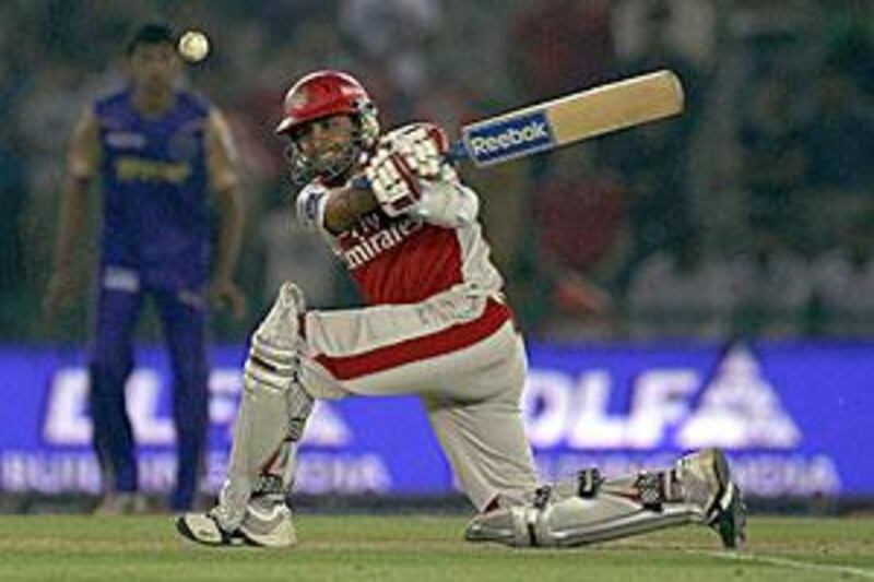 Manvinder Singh Bisla goes for a slog sweep on his way to a knock of 35, the highest for Kings XI Punjab.