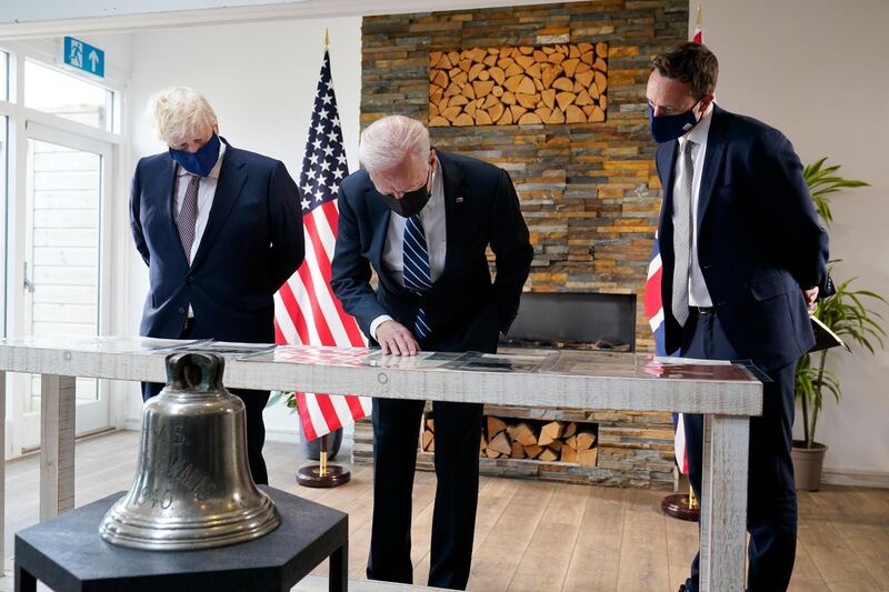 President Joe Biden and British Prime Minister Boris Johnson look at copies of the Atlantic Charter, during a bilateral meeting ahead of the G-7 summit, Thursday, June 10, 2021, in Carbis Bay, England.The Atlantic Charter is a copy of the original 1941 statement signed by FDR and Winston Churchill. (AP Photo/Patrick Semansky)