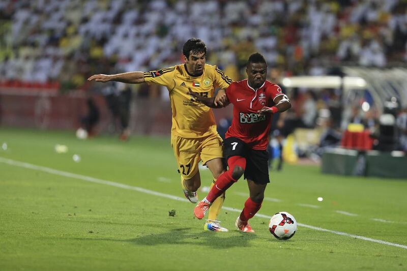 Al Wasl's Juan Culio, left, tries to steal the ball from Al Ahli's  Ismaeel Al Hamadi during their Arabian Gulf League match on Thursday in Duabi. With the 2-1 victory, Al Ahli clinched the AGL title. Sarah Dea / The National