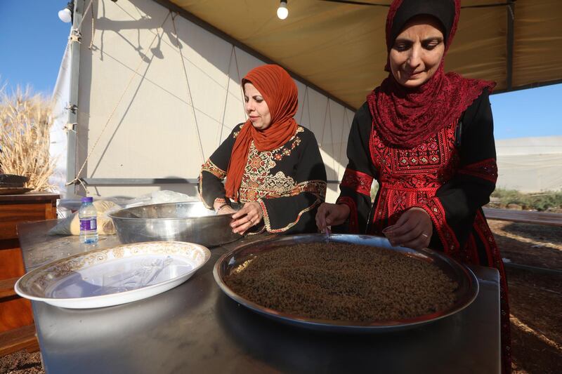 West Bank farmers and their families celebrate the first annual wheat festival by cooking traditional food using wheat to mark the end of the harvest. EPA