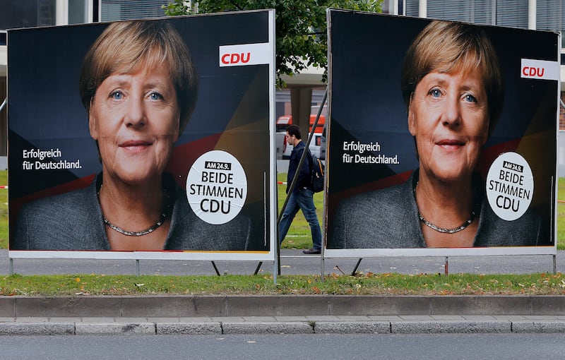 Election posters of German Chancellor Angela Merkel stand at a main street in Frankfurt, Germany, Wednesday, Sept. 20, 2017. German elections will be held on upcoming Sunday. The slogan reads "successful for Germany". (AP Photo/Michael Probst)