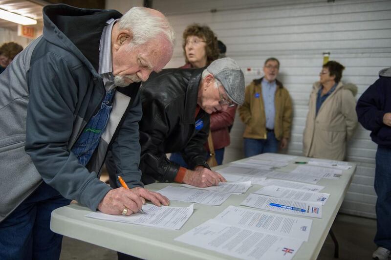 Caucus attendees sign in as they arrive at a Democratic Party Caucus at Jackson Township Fire Station on February 1 in Keokuk, Iowa. Michael B Thomas / AFP