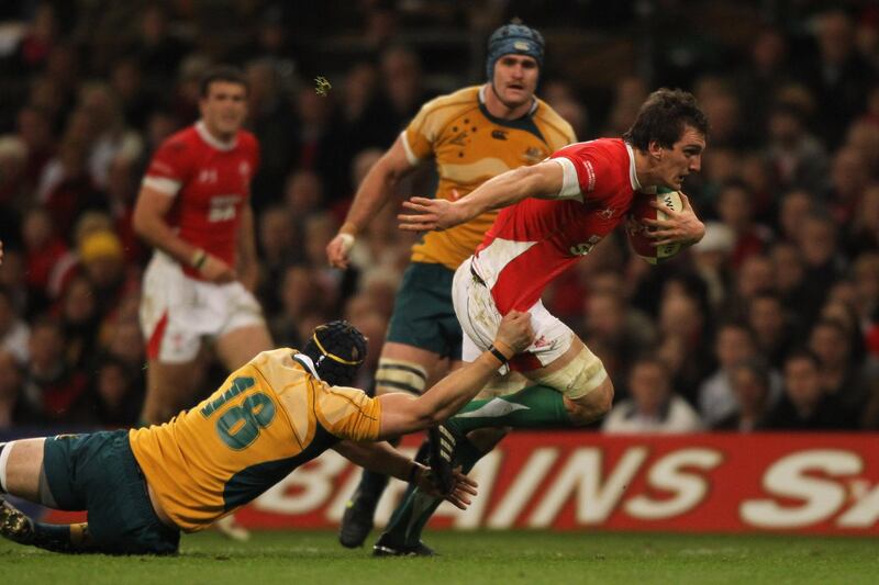 CARDIFF, WALES - NOVEMBER 28:  Sam Warburton of Wales bursts through the tackle of Mark Chisholm of Australia during the Invesco Perpetual Series match between Wales and Australia at the Millennium Stadium on November 28, 2009 in Cardiff, Wales.  (Photo by David Rogers/Getty Images)