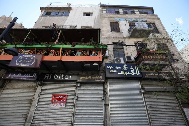 Closed shops are seen during the nationwide curfew for two days, amid fears of a rising number of coronavirus disease (COVID-19) cases in downtown Amman, Jordan. REUTERS