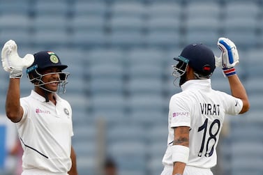 India's Mayank Agarwal, left, celebrates scoring a century with captain Virat Kohli during the second cricket test match between India and South Africa in Pune, India, Thursday, Oct. 10, 2019. (AP Photo/Rajanish Kakade)