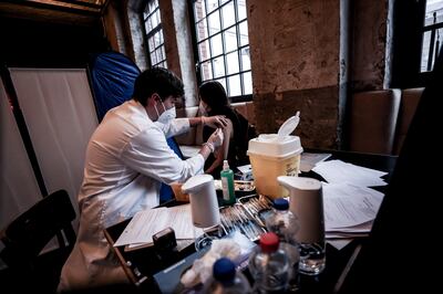 A woman obtains a coronavirus vaccine dose at a restaurant in Berlin, Germany. Photo: EPA