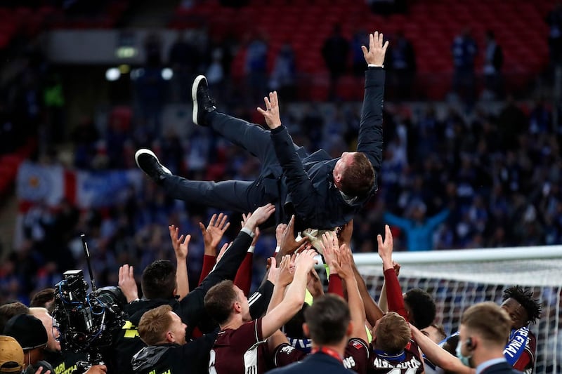 Leicester manager Brendan Rodgers is thrown into the air by his players. AFP
