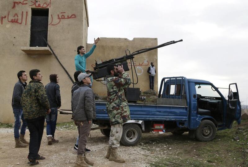 Rebel fighters from the Ahrar al-Sham Islamic Movement target Syrian regime aircraft. Khalil Ashawi / Reuters

