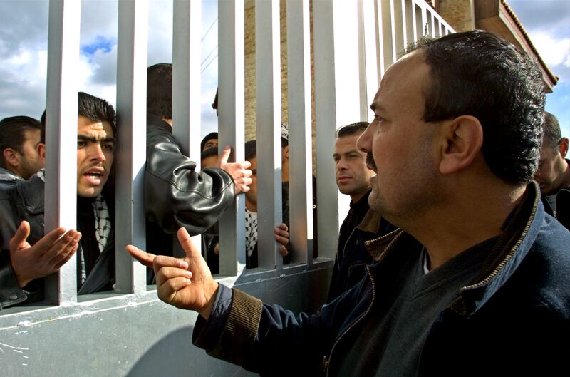 Marwan Barghouti speaks with young people demonstrating in support of Palestinian leader Yasser Arafat in January 2002 at the gates of Arafat's office in the West Bank town of Ramallah. Getty images