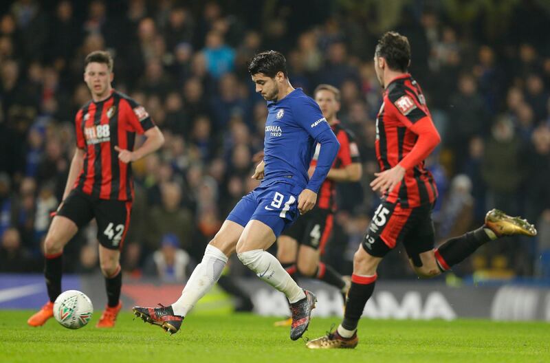 Chelsea's Alvaro Morata, centre, shoots and score his sides second goal of the game during the English League Cup quarterfinal soccer match between Chelsea and Bournemouth at Stamford Bridge stadium in London, Wednesday, Dec. 20, 2017.Chelsea won the game 2-1. (AP Photo/Alastair Grant)
