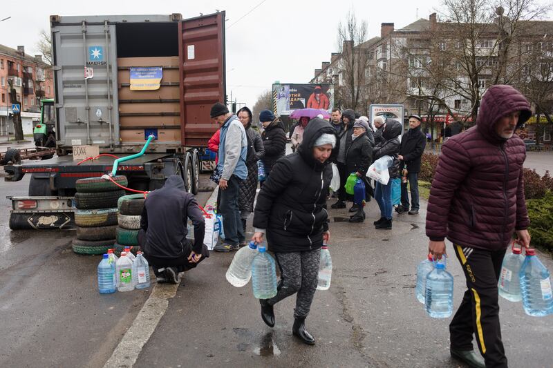Local residents receive bottled water from a truck, since there has been no running water for more than a week in Mykolaiv. Getty Images