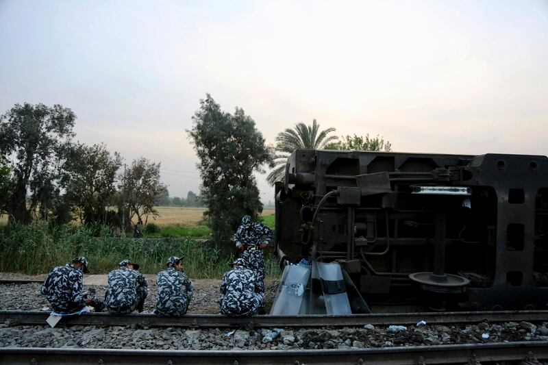 Egyptian security forces prepare to break their fast at the scene of a train derailment near Banha, the capital of Qalyubia province, Egypt. AP Photo