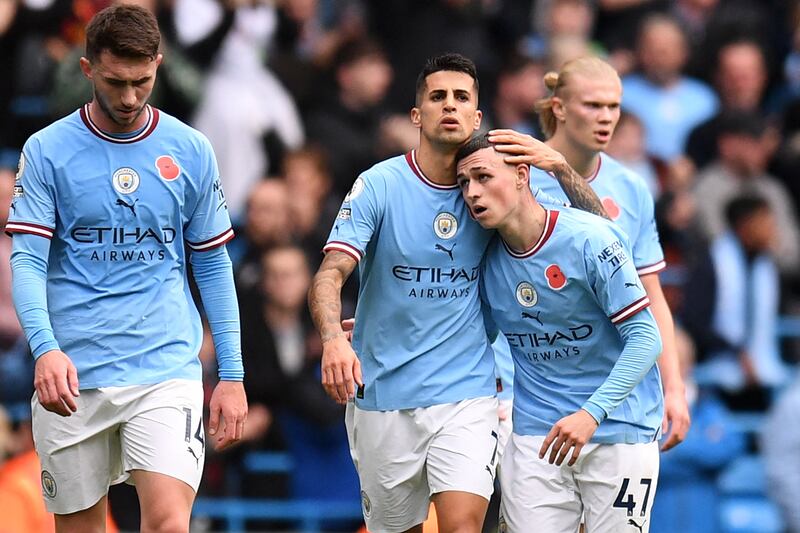 Phil Foden celebrates with teammates after scoring. AFP