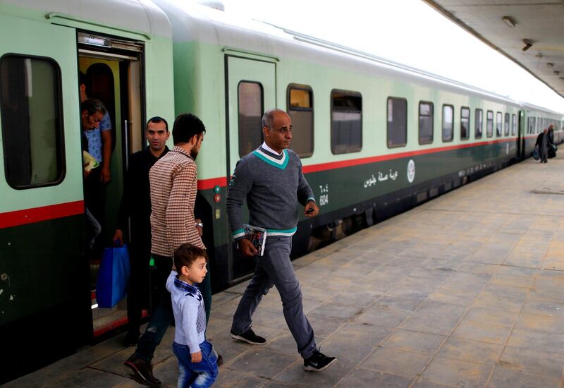 Passengers get off a train coming from Baghdad, as it arrives in Fallujah. Reuters