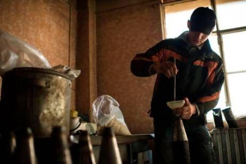 A young man makes missiles in a factory in northeastern Syria. About 100 people are killed daily in the uprising against president Bashar al Assad.