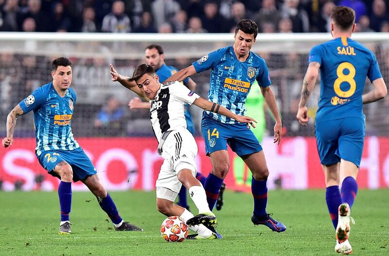 Juventus' Paulo Dybala in action with Atletico Madrid's Rodri and Jose Gimenez. AFP