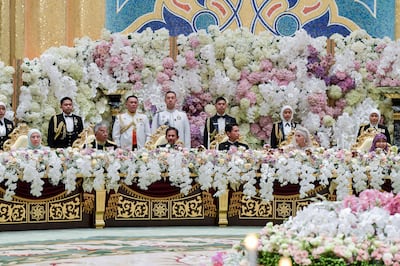 Prince Abdul Mateen and bride Anisha Rosnah at their wedding banquet in the presence of Brunei's Sultan Hassanal Bolkiah, third from left, and Queen Hajah Saleha. Photo: Brunei's Information Department