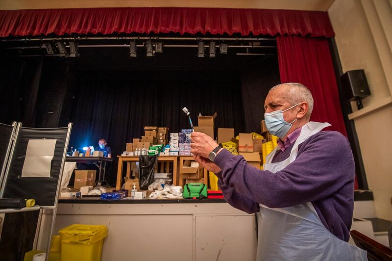 A vaccinator draws-up the vaccine into a syringe at Thornton Little Theatre near Blackpool, north-west England which is being used as a vaccination centre. Getty Images