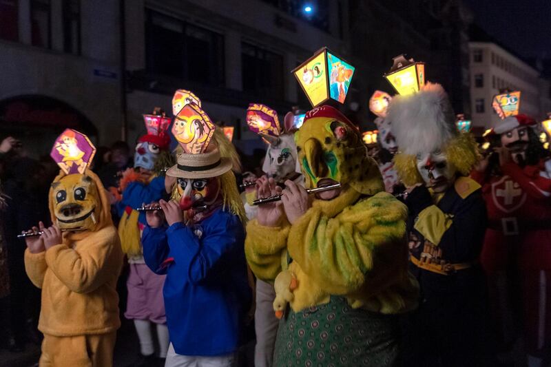 Revelers wearing lanterns parade through the streets during the Morgenstreich in Basel, Switzerland. EPA