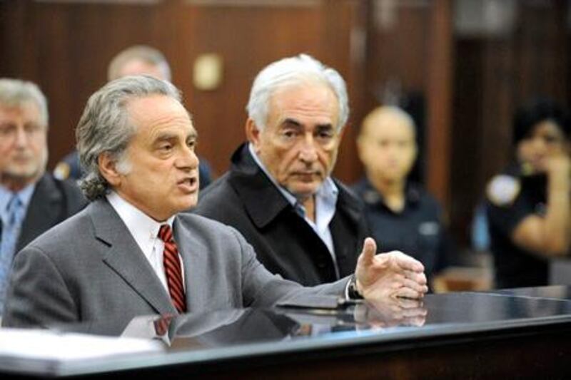 Dominique Strauss-Kahn, managing director of the International Monetary Fund (IMF), right, appears with attorney Benjamin Brafman at his arraignment in Manhattan criminal court in New York, U.S., on Monday, May 16, 2011. Strauss-Kahn, accused of attempting to rape a hotel housekeeper, was ordered held without bail by a New York judge after prosecutors argued he presented a flight risk. Photographer: Andrew Gombert/Pool via Bloomberg *** Local Caption *** Dominique Strauss-Kahn; Benjamin Brafman 849363.jpg