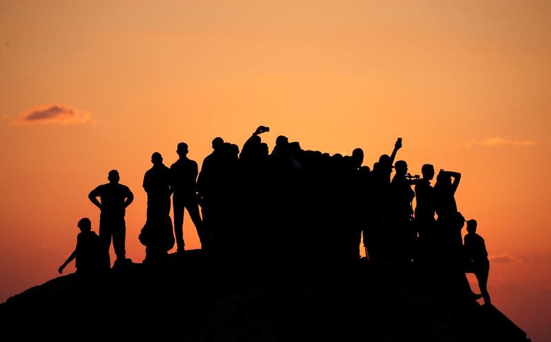 Palestinian demonstrators gather on top of a hill during a protest calling for lifting the Israeli blockade on Gaza, near the maritime border with Israel, in the northern Gaza Strip. Reuters